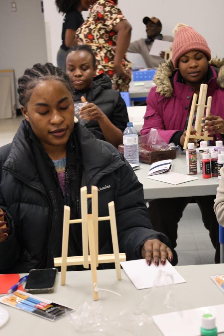 Youth painting on easels during an Empower Youth Canada art workshop.