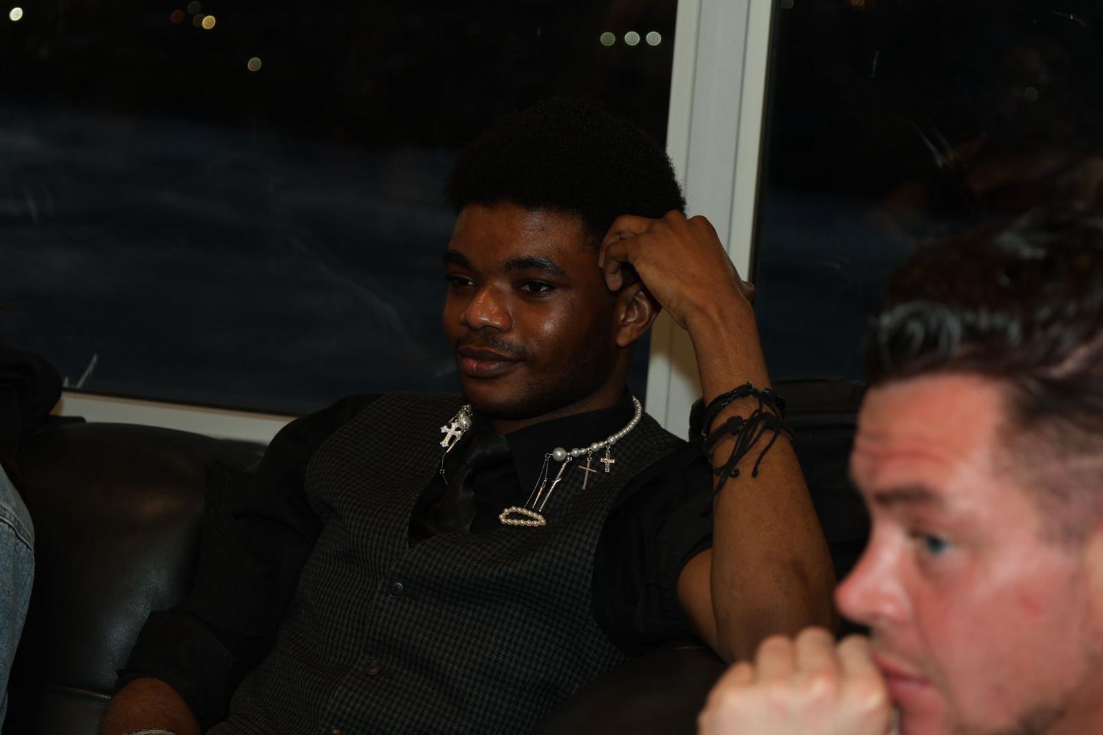 Youth participant listening during a community gathering.