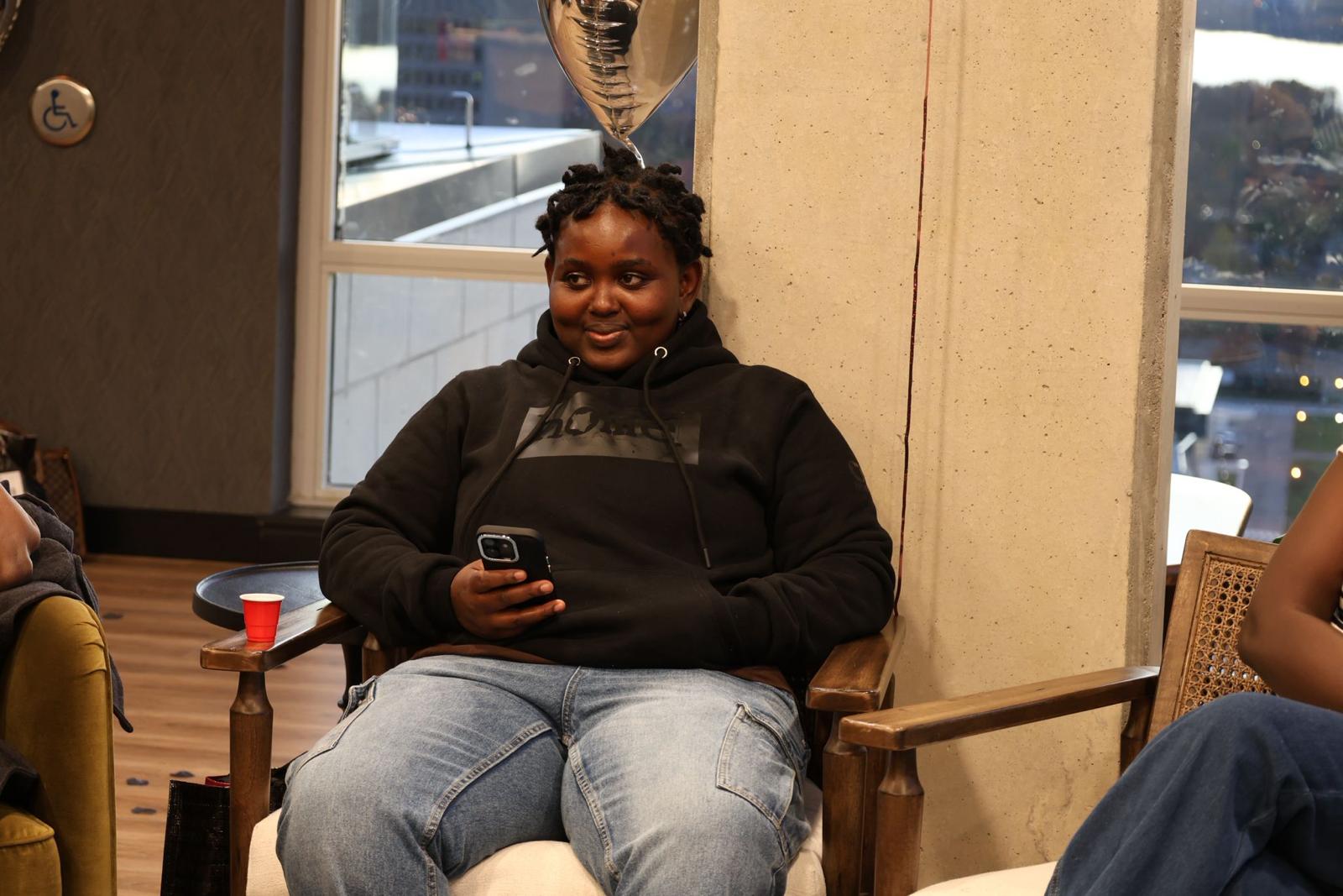 Youth participant seated during a community event.